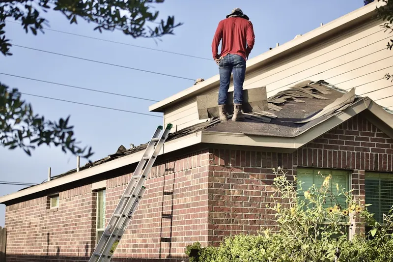 Professional roofer working on a residential roof in Galleria